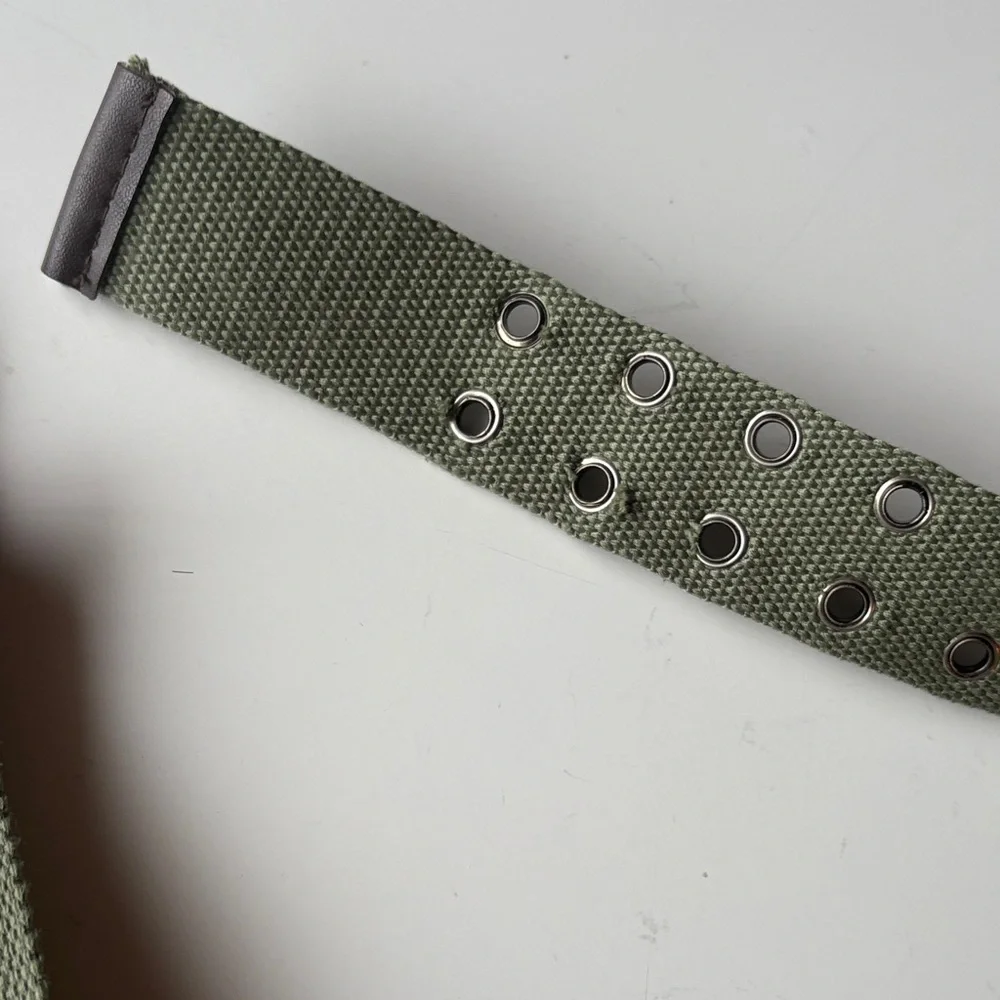 Olive Green Canvas Belt with brown accents. Silver tone hook loops.